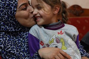Zainab Al Ali (far left) spends some family time with her her daughter Razan Abdallah (center) and her son, Ramez Abdallah in their home in Tripoli, Lebanon on March 22, 2016. This Lebanese family is beneficiaries of the National Poverty Targeting Program. Photo © Dominic Chavez/World Bank